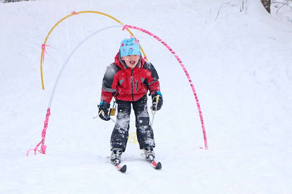 Mica Wallin tries to catch some snowflakes on his tongue as he skis down a hill at Bull Mountain. (Patrick Davies photo-Williams Lake Tribune)