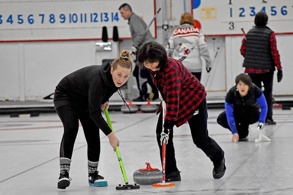 Kristi Denby (from left) and Wendy Miller sweep while Naomi Miller keeps an eye on her shot Sunday during the women’s ‘A’ division final at the Williams Lake Curling Club’s annual Joint Men’s and Women’s Bonspiel. Denby, Wendy and Naomi were a part of Debbie Rand’s rink, who won the championship over the team of skip Donna Shiach, Carol Johnson, Betty Dryden and Kirstin Lauren. (Greg Sabatino photo)
