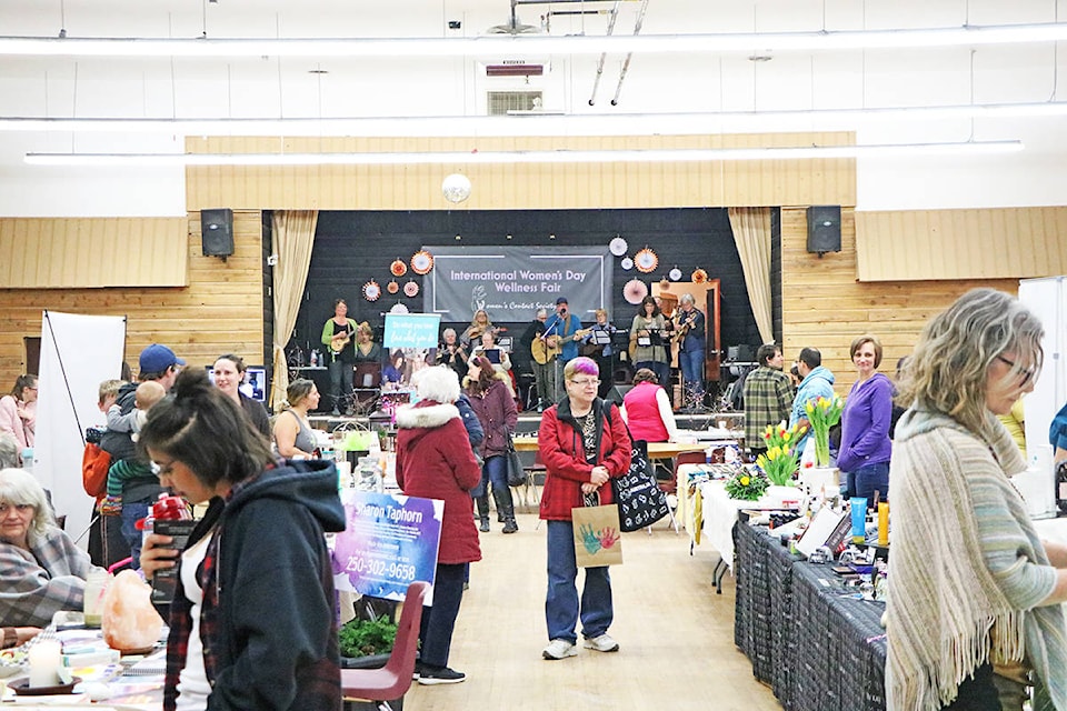 Lakecity men and women browse the wares and services featured at the second annual International Women’s Day Wellness Fair at the Elks Hall. (Patrick Davies photo - Williams Lake Tribune)