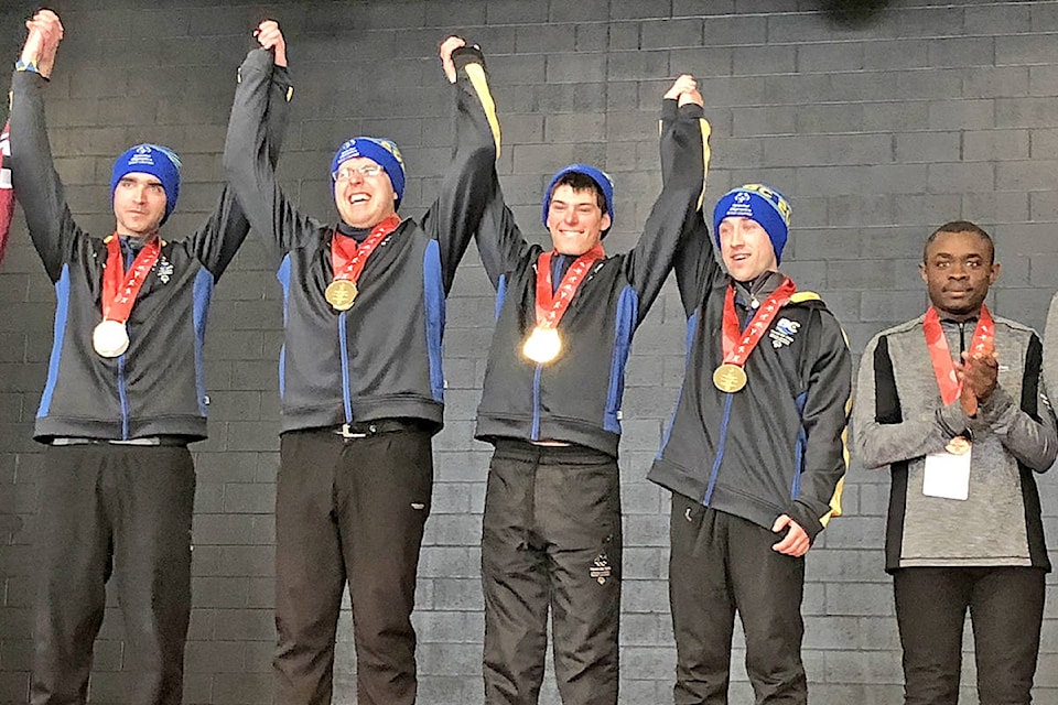 Williams Lake snowshoe athlete Austin Weber (second from left) raises his arms after winning a gold medal at the Special Olympics National Games in Thunder Bay, Ont. late last month. (Photo submitted)