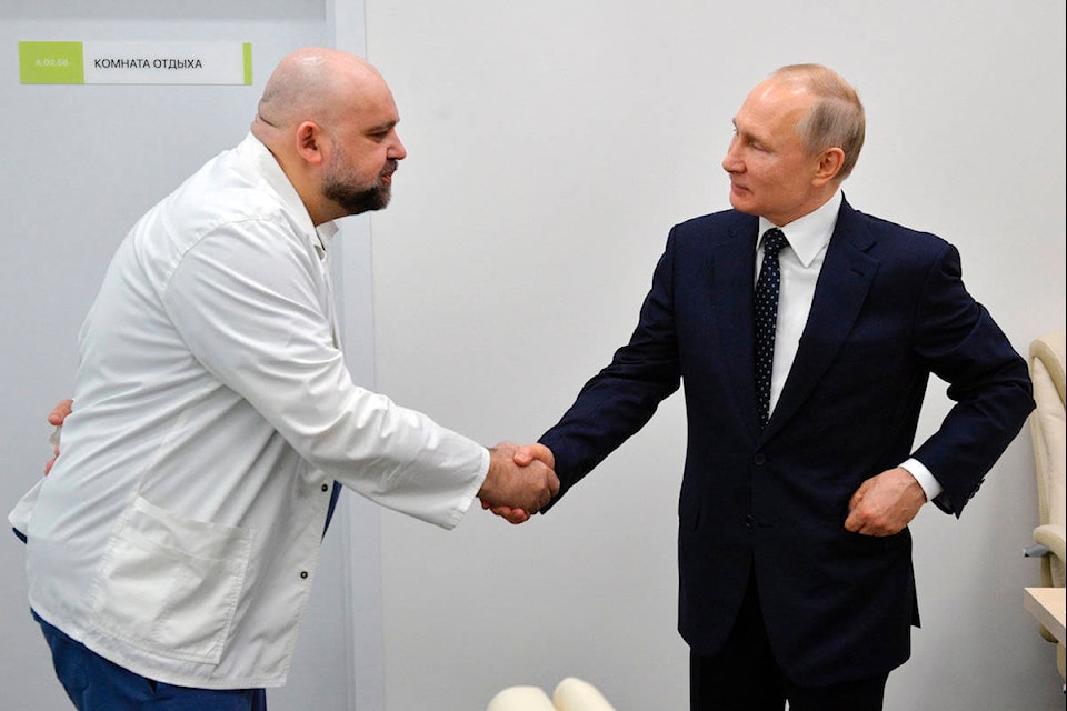 FILE In this file photo taken on Monday, March 23, 2020, Russian President Vladimir Putin, right shakes hands with the hospital’s chief Denis Protsenko during his visit to the hospital for coronavirus patients in Kommunarka, outside Moscow, Russia. The chief doctor of Moscow’s top hospital for coronavirus patients says he has tested positive for the virus, a statement that comes a week after his encounter with President Vladimir Putin. Putin visited the Kommunarka hospital on March 23. (Alexei Druzhinin, Sputnik, Kremlin Pool Photo via AP, File)