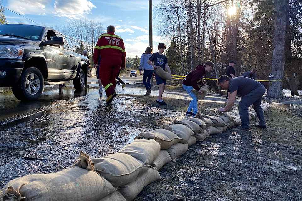 Water was rushing through the culvert and over the road on Westcoast Road in Wildwood Saturday. (Angie Mindus photo - Williams Lake Tribune)