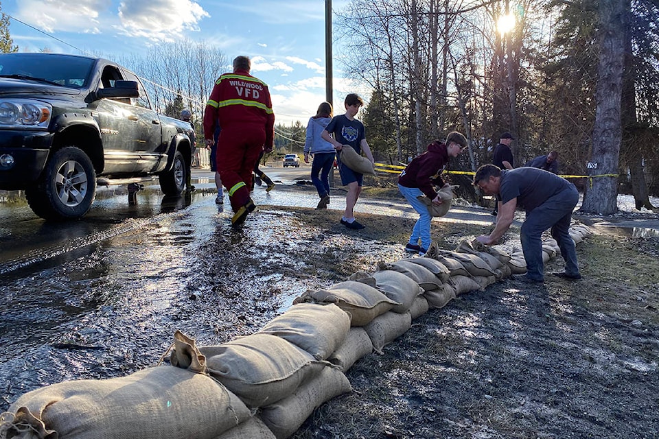 Water was rushing through the culvert and over the road on Westcoast Road in Wildwood Saturday. (Angie Mindus photo - Efteen)