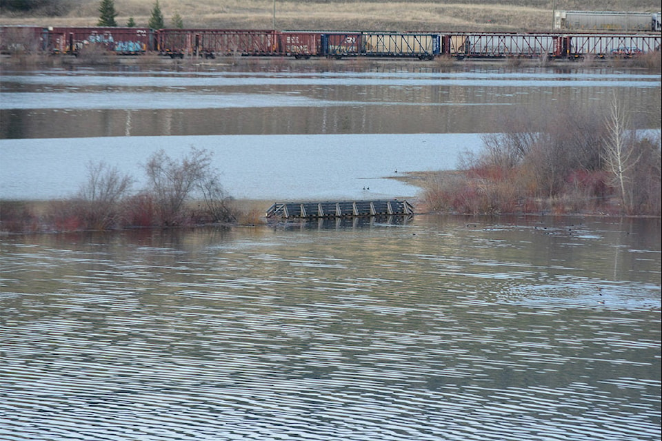 Water levels of Williams Lake have risen almost three feet in less than 48 hours as seen here the pedestrian bridge at Scout Island is partially submerged in water Thursday morning. (Monica Lamb-Yorski photo - Williams Lake Tribune)