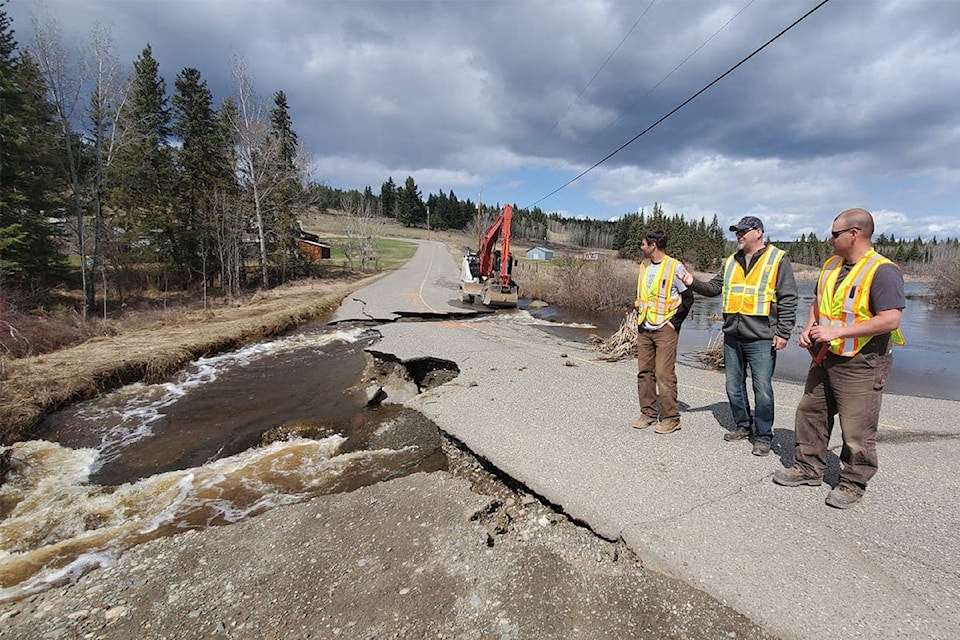 Ron McCormack, director of operations and CVSE manager MOTI (centre) discusses options for providing temporary access to residents cut off by the washout on Huston Road in the 150 Mile House area with Rob Kielman (left) and Skyler McCarthy of Dawson Road Maintenance Thursday afternoon.