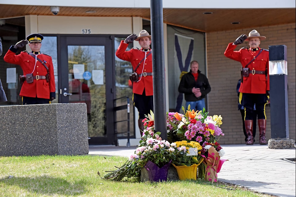 Lakecity residents stood across the street from the Williams Lake RCMP detachment Friday to watch the RCMP pay tribute to victims of the Nova Scotia mass shooting. (Angie Mindus photo - Williams Lake Tribune)