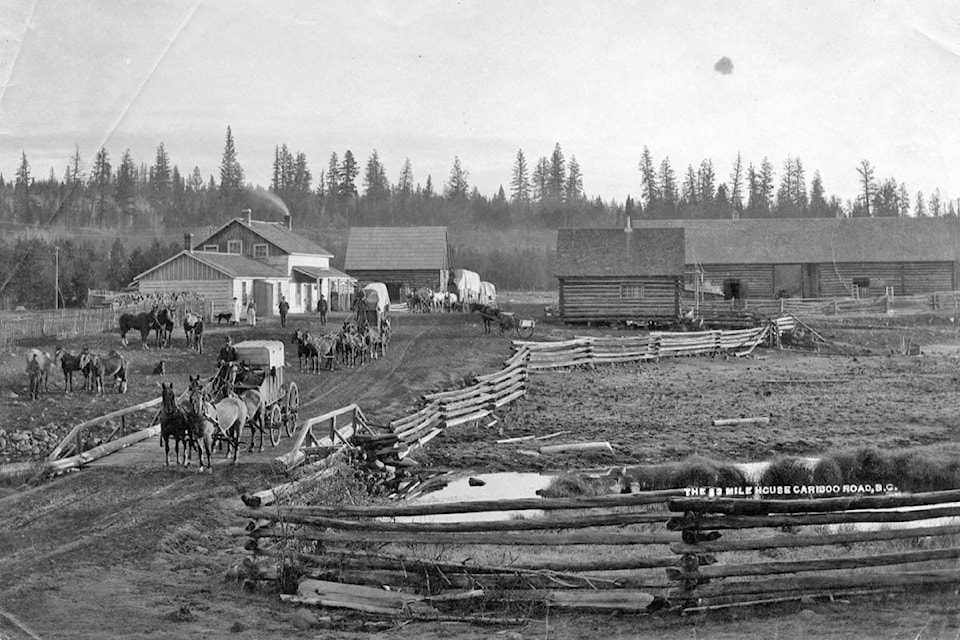 A photo of station wagons passing through 83 Mile House on the Cariboo Waggon Road. (BC Archives photo)