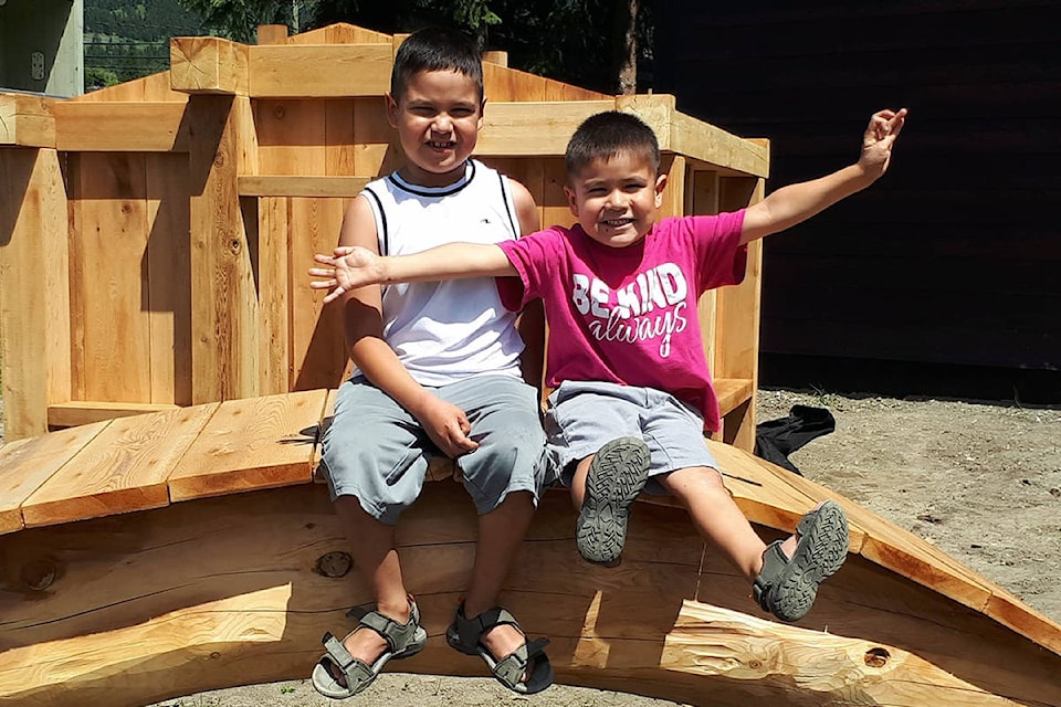 Brothers Jericho and Shephard Murphy-Lulua strike a pose at a new natural playground being installed at daycare Little Mukluks. (Rebecca Dyok photo)