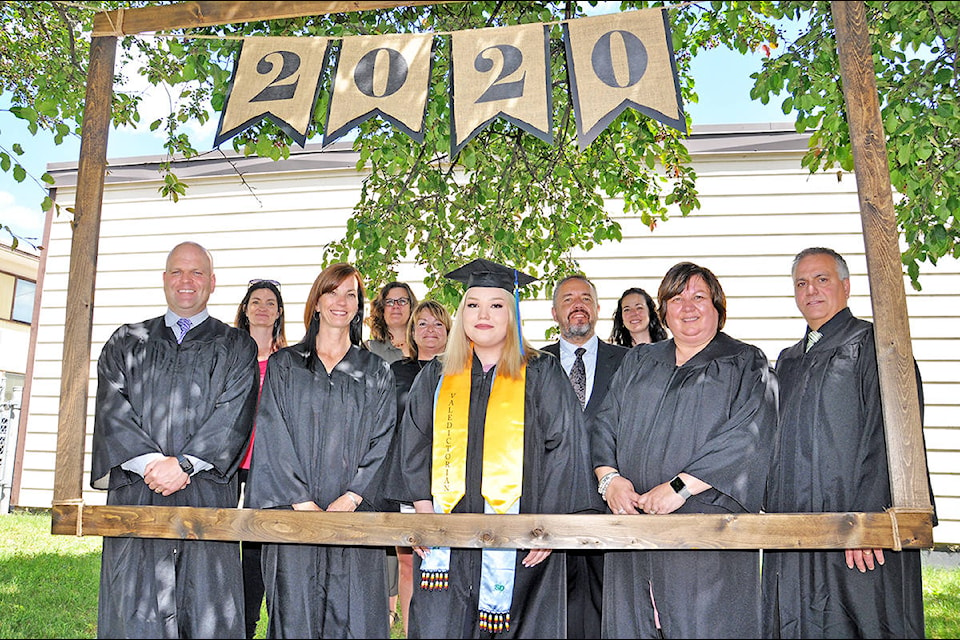 Skyline valedictorian Layla Wycotte (front, centre) stands in the photo booth alongside school staff Bev Dawes (back from left), Heather Auger, Saibra Larden, Gord Weber, Shelley Cameron, principal Curt Levens (front from left), Dena Gysel, Patti Stolar and Peter Bowman Wednesday during the school’s graduation ceremony. (Greg Sabatino photo - Williams Lake Tribune)