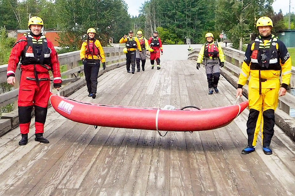 Horsefly Volunteer Fire Dept. members cross the Horsefly River bridge during swift water technician certification training, taken June 26 - 28. (John Hollan and Wayne Johnson photos)