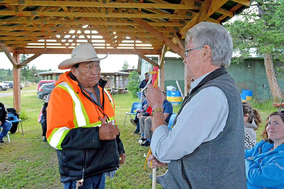 Esk’etemc traditional wellness co-ordinator Fred Johnson Sr. presents Williams Lake Mayor Walt Cobb with a talking stick at the Esk’et Arbor on Tuesday, July 7. (Monica Lamb-Yorski photo - Williams Lake Tribune)