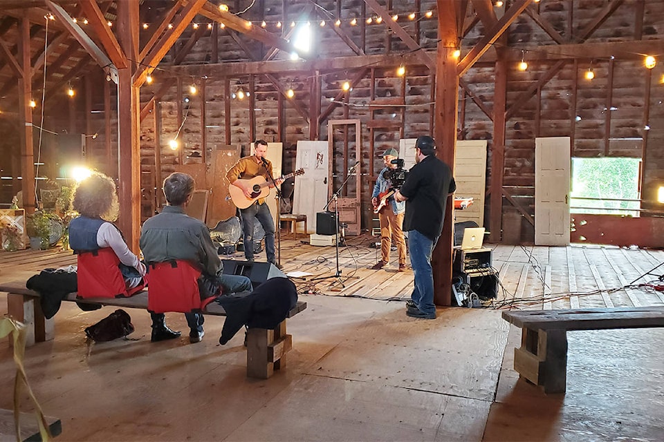 The Lyle Bats project featuring Brent Morton (left) and Brandon Hoffman perform at the Onward Ranch barn while Rick Magnell (right) films the Performances in the Park concert for a video production series. With the COVID-19 pandemic, the concert series is not taking place in Boitanio Park, but four concerts are being filmed in the Cariboo with small audiences in attendance. (Monica Lamb-Yorski photo - Efteen)