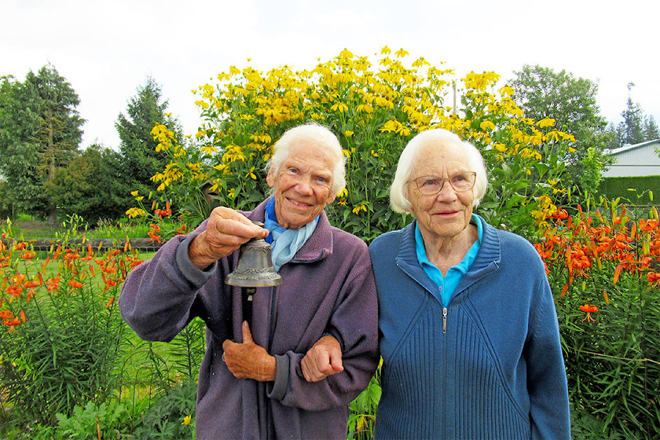 Myra Riedemann, left, and her sister Sophie Riedemann still cherish a souvenir bell they received for gifting Williams Lake Sacred Heart Catholic Church with bells in 1967. (Photo submitted)