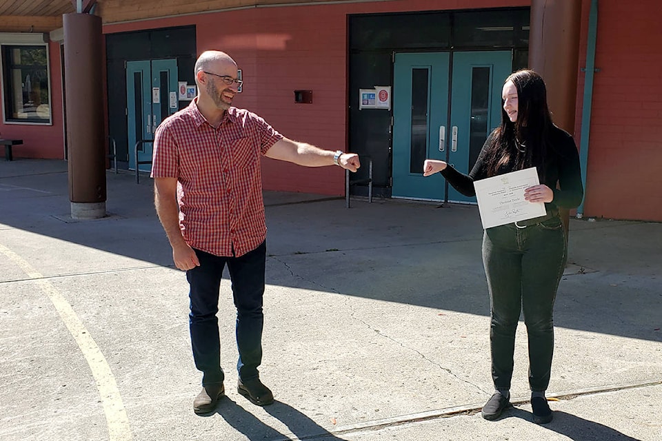 Lake City Secondary School principal Craig Munroe (left) congratulates Cheleine Doyle on achieving the Governor General’s Academic Medal for graduating in June 2020 with an overall academic average of 95.92 per cent. (Monica Lamb-Yorski photo - Williams Lake Tribune)