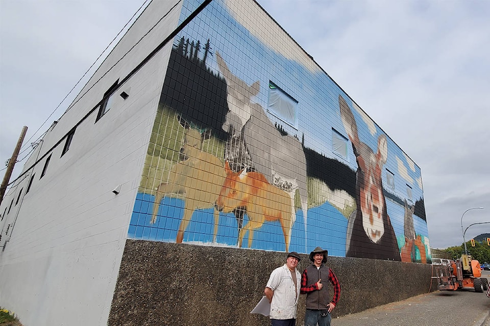 Mural artist Dwayne Davis, left, and his son Steven are working on a cow moose mural in Williams Lake, furthering the efforts of Cow Moose Sign Project creator Dan Simmons. (Monica Lamb-Yorski photo - Williams Lake Tribune)