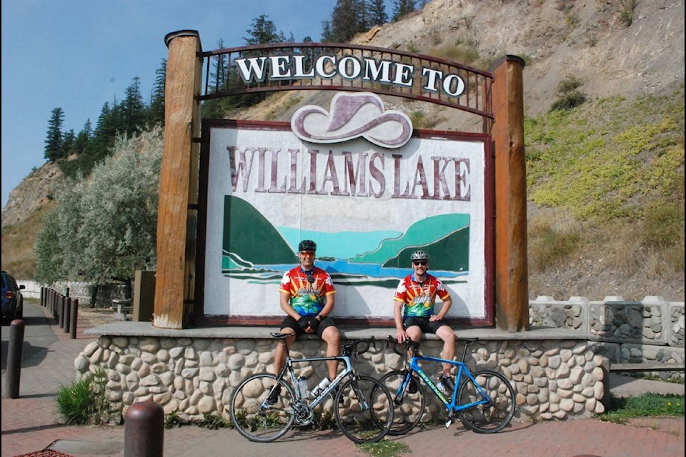 Williams Lake RCMP Cst. Nick Brown and Cst. Kevin Wiebe take a break at the Welcome to Williams Lake sign while taking part in this year’s virtual Cops for Cancer Tour de North ride. (Photo submitted)