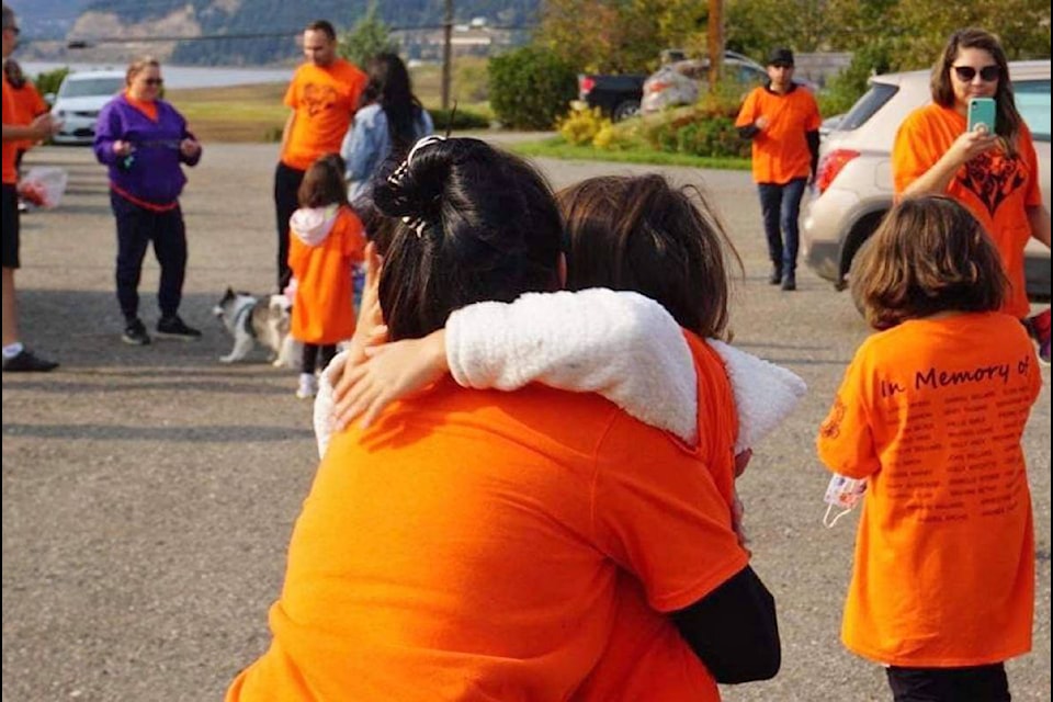 Ann Guichon hugs her daughter Kyra on Orange Shirt Day. (Gwitne Alphonse photo)