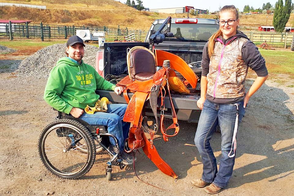 Thompson Rivers University Applied Sustainable Ranching Program students Kevin Cunin (left) and Wendy Meijdam show off a modified saddle recently made for Cunin, who is paralyzed from the chest down, so he can compete in team roping. (Rebecca Dyok photo)