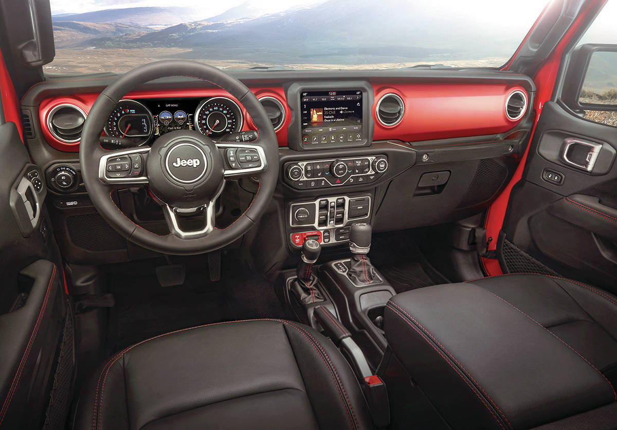 The dash layout of the Gladiator looks like that of any other Wrangler, which is to say its a busy spot. Note that one shift lever is for the transmission and the other is for operating the transfer case for high-low gear range. PHOTO: FCA