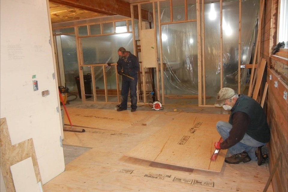 Owen Knox (left) and Paul Hearsey lay the plywood sub-floor. (Photos submitted)