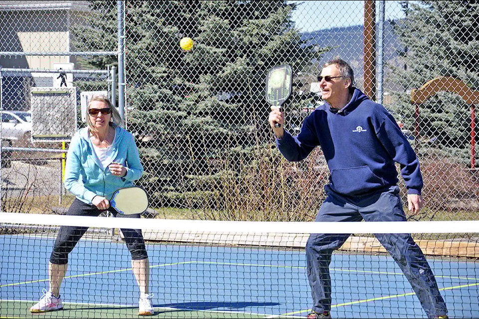 Williams Lake Pickleball Club members Marykay Simpson and Roy Simpson compete in a friendly game of doubles April 12 at the Kiwanis Tennis Courts in the lakecity. (Greg Sabatino photo - Efteen)