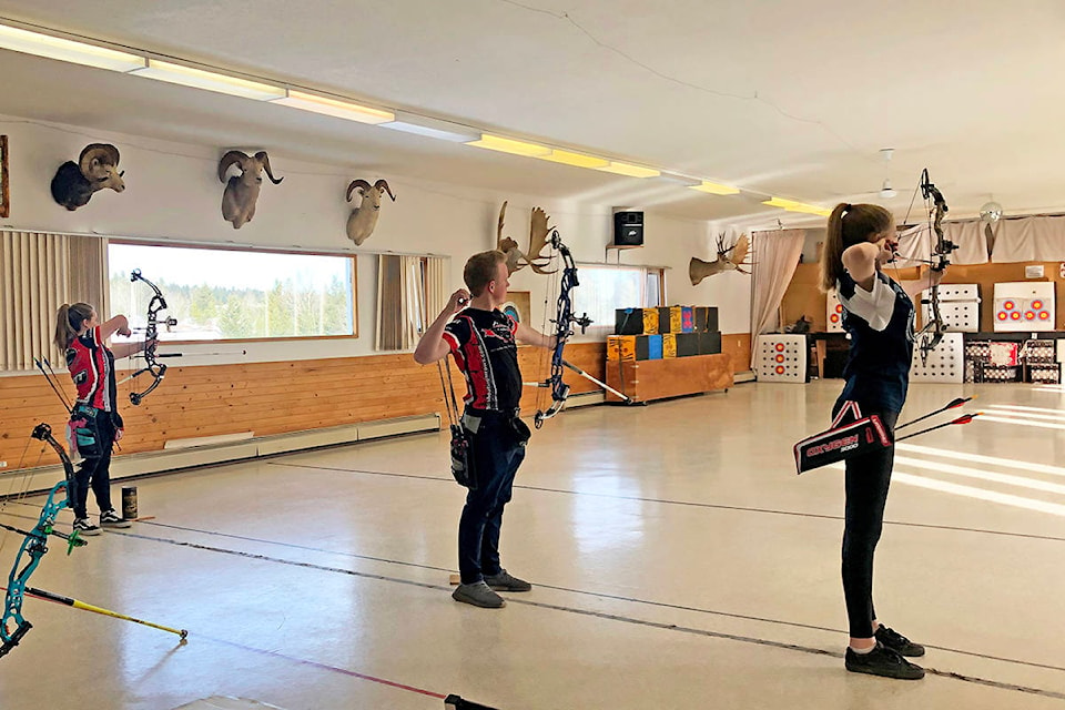 Cariboo Archers Joelle Thurow (from left), Ty Thurow and Haley Plewes line up during the virtual Vegas shoot held last month in Williams Lake. (Photo submitted)