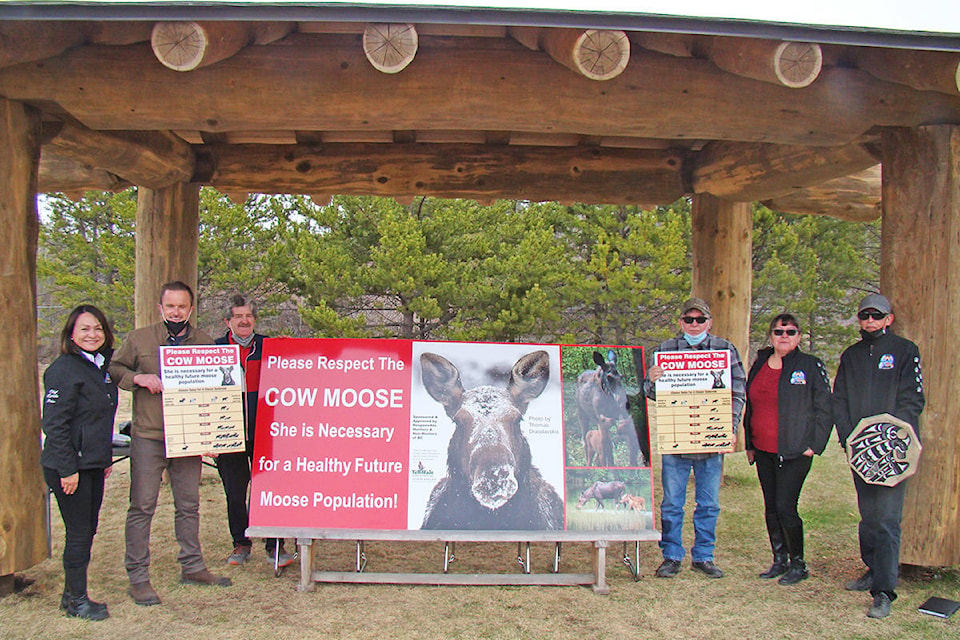 Lynda Price, Chief of Ulkatcho First Nation, left, Dylan Walsh, principal of Anahim Lake Elementary Junior Secondary School, Lewis Budgell, UFN education director, Gary Holte, UFN Elders’ Executive Council, Mabelene Leon, UFN Council and Allen Louie, UFN Council stand with their new signs. (Photo submitted)