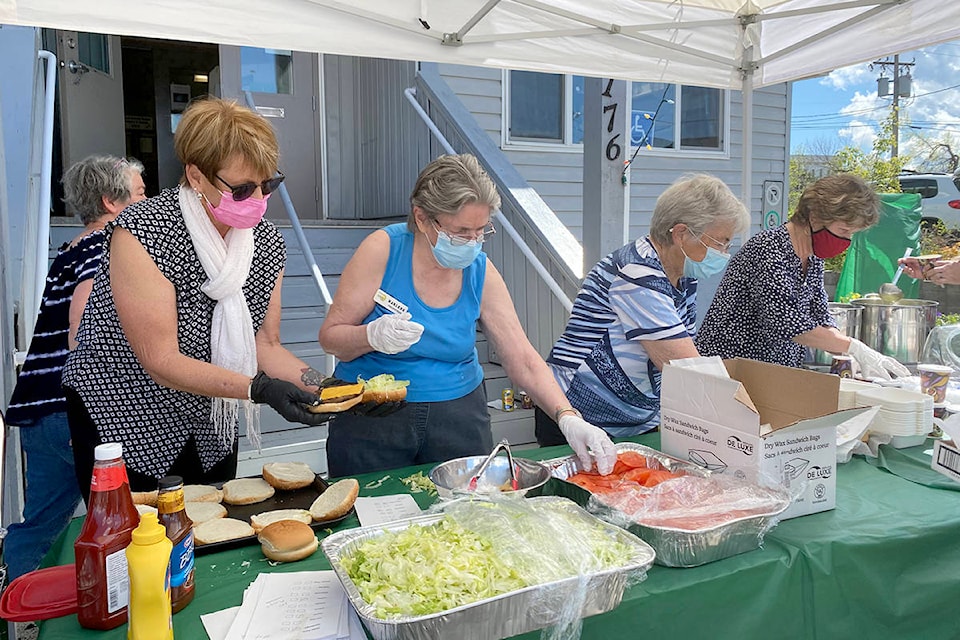 Seniors Activity Centre volunteers Rose Pinchbeck, Marlene Davis, Dorothy Unrau and Corey Patterson make lunches at the Old Fashioned Drive In Car Hop Friday, May 14. (Angie Mindus photo)