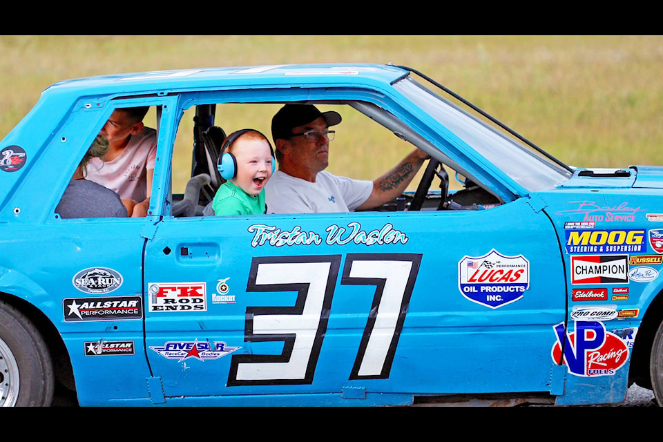 Young Thunder Mountain Speedway fan Grayson Busat is over the moon with excitement after getting the chance to hop inside a stock car driven by TMS vice-president Ken Waslen Saturday night during the first racing event held at the local race track since September of 2019 because of the cancellation of last year’s season due to the COVID-19 pandemic. (Shannon Fisher photo)