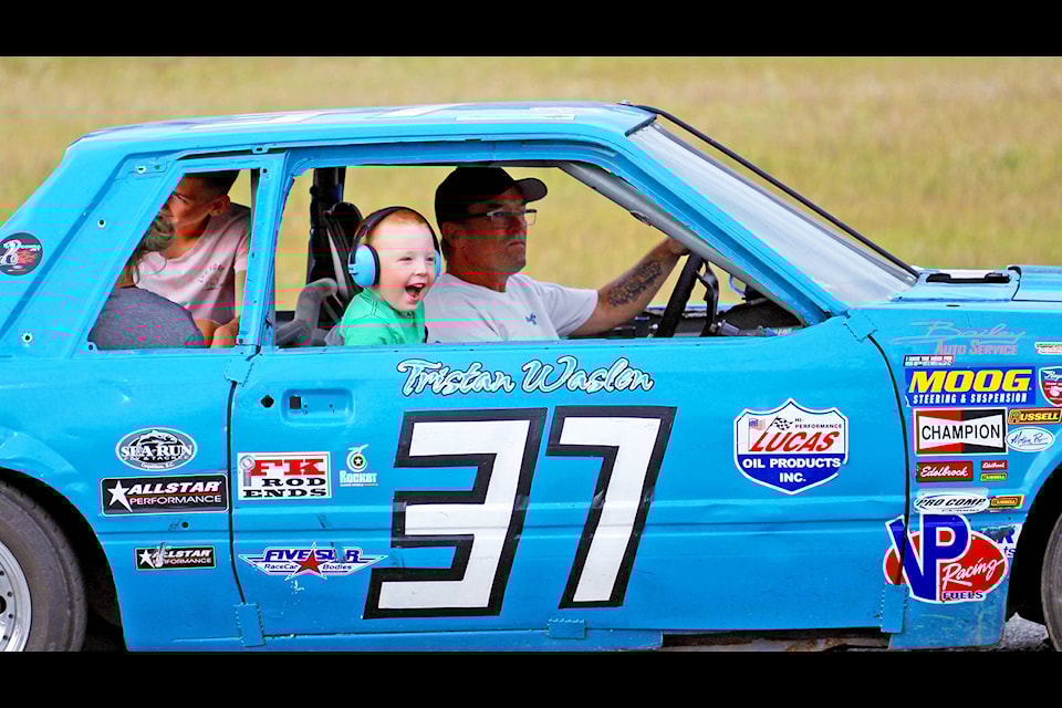 Young Thunder Mountain Speedway fan Grayson Busat is over the moon with excitement after getting the chance to hop inside a stock car driven by TMS vice-president Ken Waslen Saturday night during the first racing event held at the local race track since September of 2019 because of the cancellation of last year’s season due to the COVID-19 pandemic. (Shannon Fisher photo)