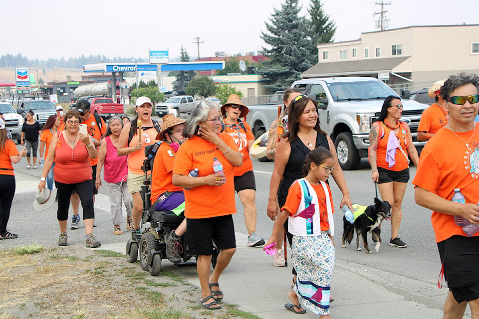 Around two dozen Warrior Walkers and members of the Canim Lake Band marched through 100 Mile House down Highway 97 Thursday afternoon. (Patrick Davies photo - 100 Mile Free Press)