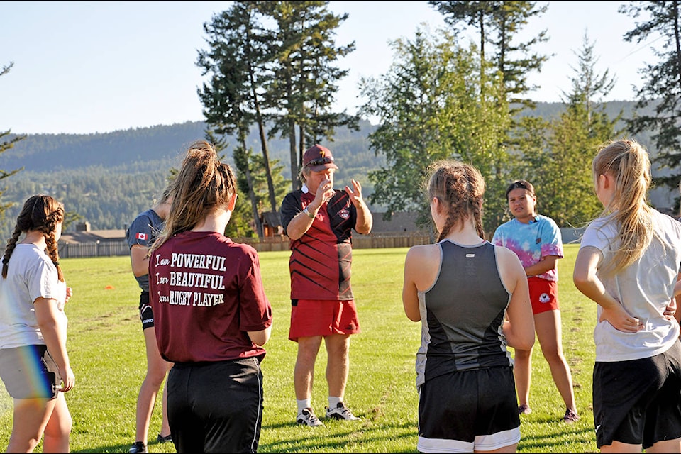 Williams Lake rugby coach Morley Wilson runs over some drills with a team of girls preparing to travel to Edmonton early next month to compete at Rugbyfest. (Greg Sabatino photo - Efteen)