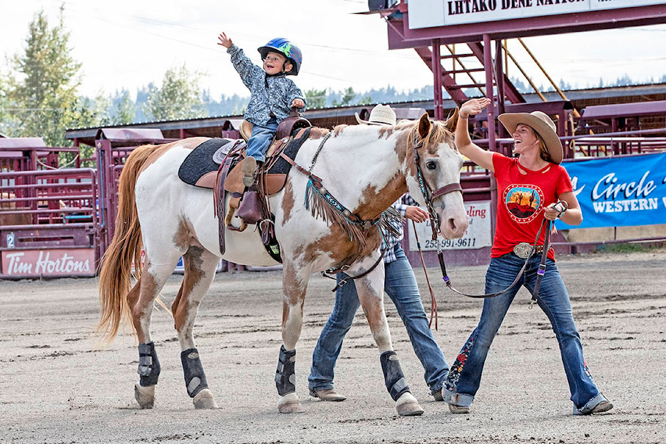 Two-year-old Hunter Madder takes part in the peewee lead line event with the help of Williams Lake Stampede Princess Kennady Dyck during the BC Barrel Racing Association Finals during the weekend in Quesnel. (Leo Prince photo)