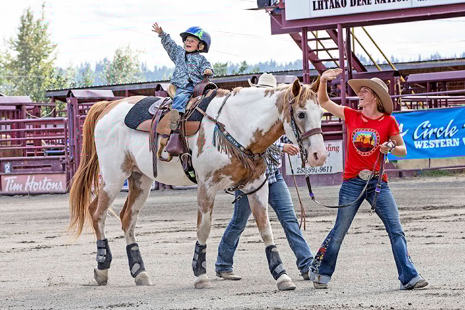 Two-year-old Hunter Madder takes part in the peewee lead line event with the help of Williams Lake Stampede Princess Kennady Dyck during the BC Barrel Racing Association Finals during the weekend in Quesnel. (Leo Prince photo)