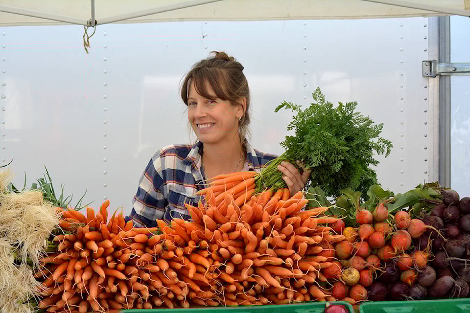 Brianna van Wijngaard uses a broadfork to till the soil at her Puddle Produce Farm above the old Soda Creek townsite. (Monica Lamb-Yorski photo - Efteen)
