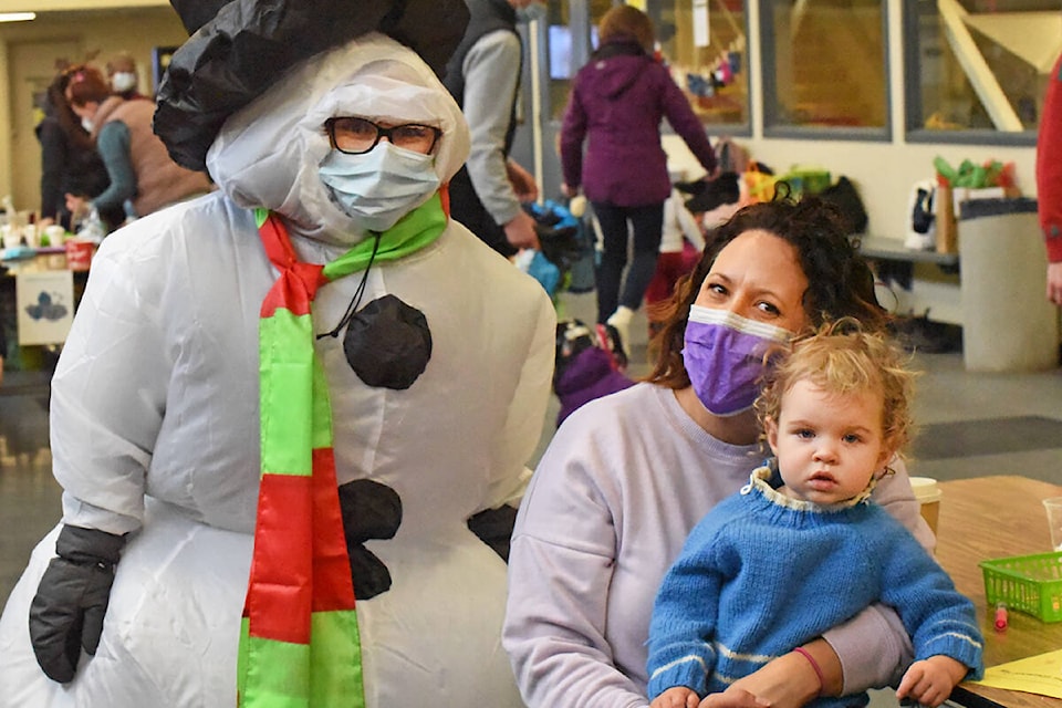 Frosty the Snowman (left), Alecia Harms, and Lucy Radolla were creating a melting snowman during the Winterfest event. (Ruth Lloyd photo - Williams Lake Tribune)