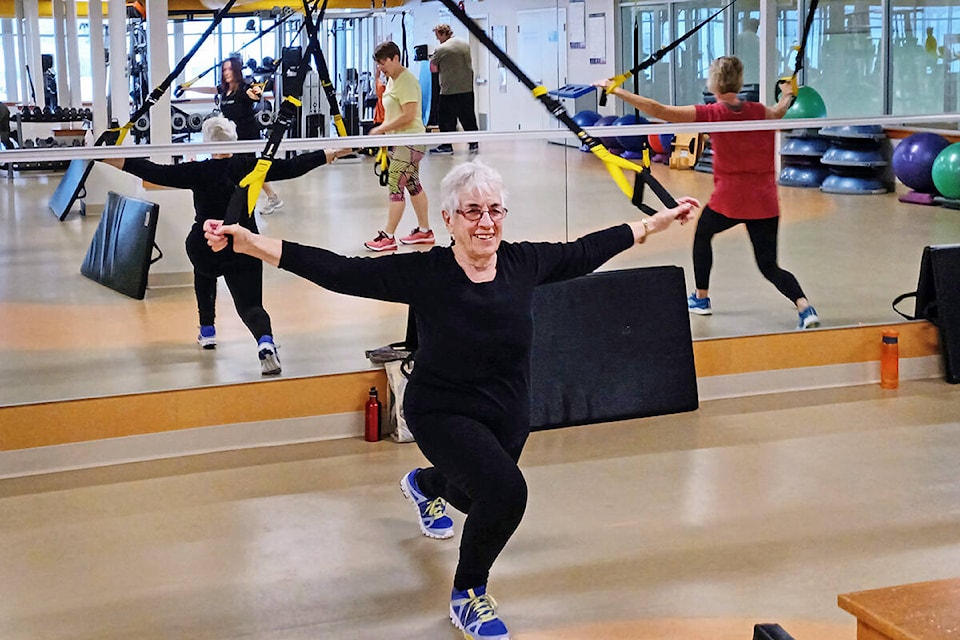 Ruby Willams (centre) does her TRX workout during a fitness class at the Cariboo Memorial Recreation Centre in Williams Lake on her 88th birthday this month. (Robyn Dawes photo)