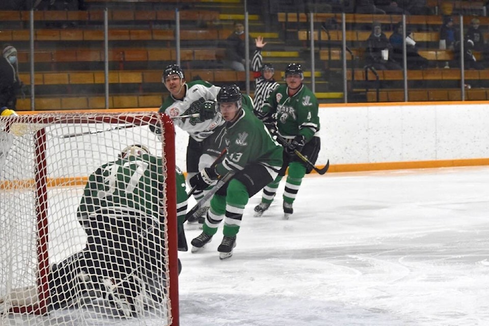 Stampeders Alumni Aaron Zurak with Stampeders Cory Loring and Alumni Cliff Philpot behind him as alumni goalie Justin Foote stops the puck. (Monica Lamb-Yorski photo - Williams Lake Tribune)