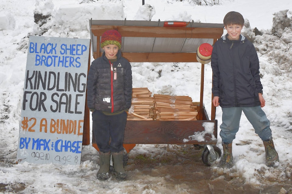 The Black Sheep Brothers Max (left) and Chase at their roadside kindling business in the winter, using waste wood and salvaged slash. (Ali Krimmer photo)