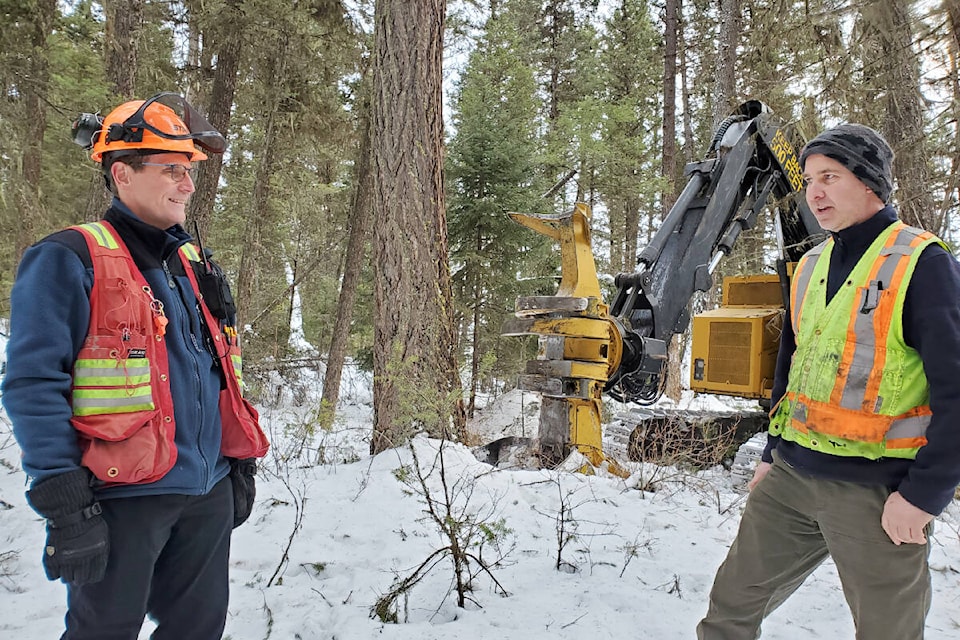 Consulting forester Ken Day, left, checks in with contractor Peter Nilsson who is doing fuel management work in the forest off the Chimney Valley Road. (Monica Lamb-Yorski photo - Williams Lake Tribune)
