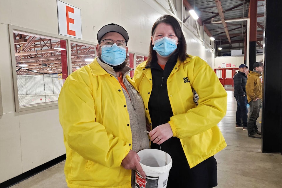 Adam Moreash, left, and Kyleen Toyne sell 50-50 tickets during the Stampeders versus Nechako North Stars game at the Cariboo Memorial Recreation Complex Friday, Feb. 11. (Monica Lamb-Yorski photo - Efteen)