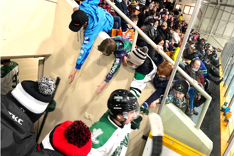 Young Williams Lake Stampeders fans reach out in hopes of a fist bump as players return to the ice after a break. The Stamps battled the Quesnel Kangaroos in Round Two of the CIHL playoffs March 4. (Angie Mindus photo - Efteen)