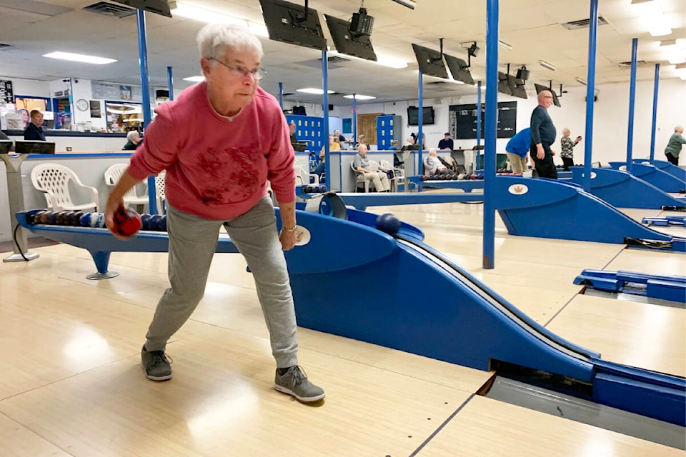 Joan Foster eyes up her shot as she bowls during seniors’ league play on March 11, 2022 at the Cariboo Bowling Lanes. (Ruth Lloyd photo -Williams Lake Tribune)