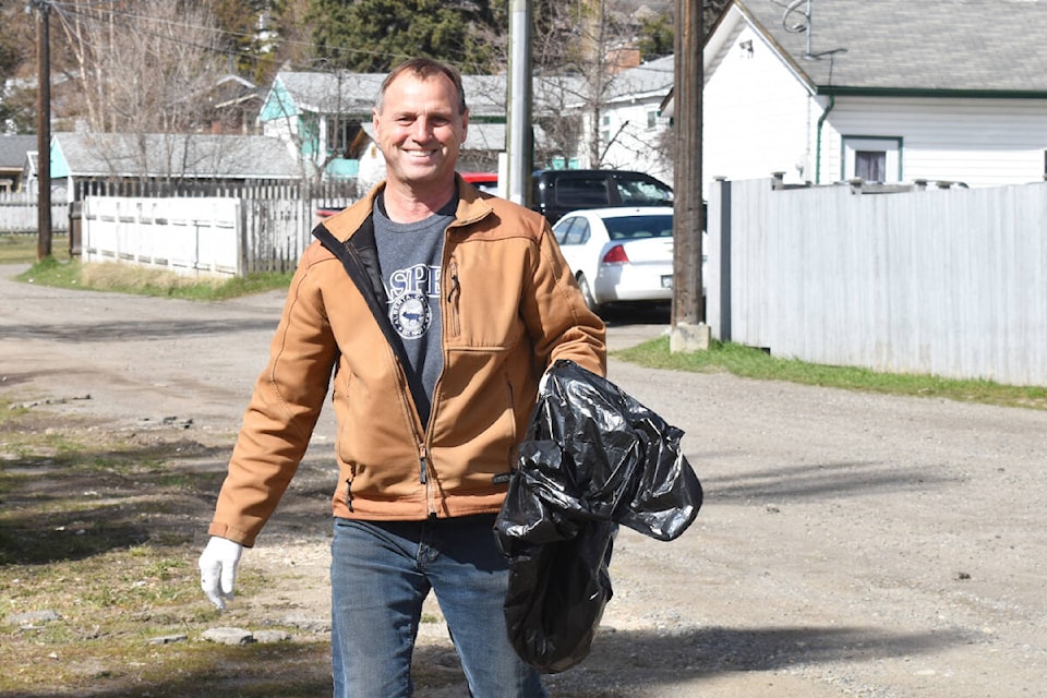 Al Tranq picks up trash in an alley during the Second Annual Bigg Earth Day Garbage Pick-up. (Monica Lamb-Yorski photo - Williams Lake Tribune)