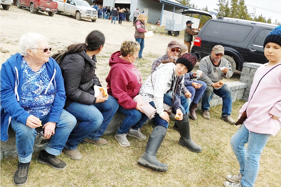 Community members enjoy socializing at a yard sale held on May 1 at Tatlayoko Lake. (Linda Lou Howarth photo)