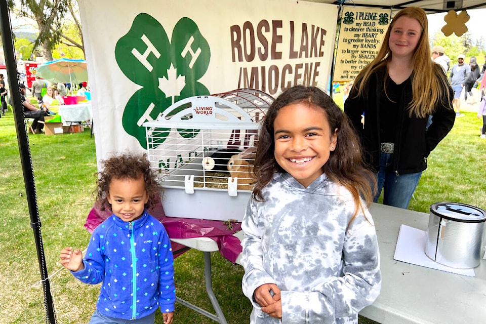 Royce, 3, and Nyssa, 8, Domi enjoy a visit with some bunnies at the Children’s Festival thanks to Heidi Van Beers and the rest of the members of the Rose Lake/Miocene 4-H Club who set up a booth at the festival in Boitanio Park. (Angie Mindus photo - Williams Lake Tribune)