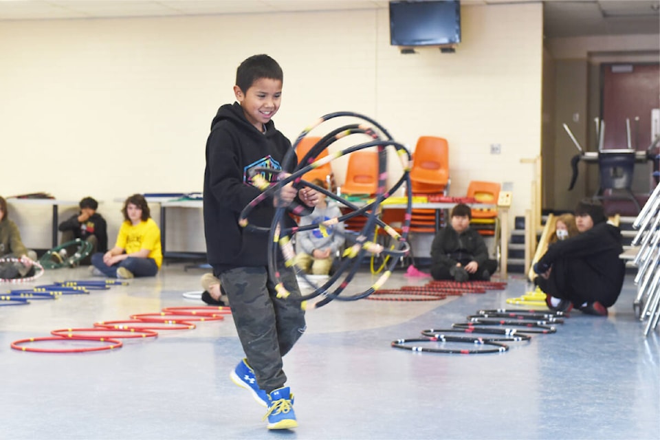 Kyrann Wycotte, in centre, a student from Marie Sharpe was helping demonstrate different hoop dance moves for a Grade 7 class at Lake City Secondary School - Columneetza campus. Francis Johnson was teaching the final in a series of three workshops for the group on May 27. (Ruth Lloyd photo - Williams Lake Tribune)