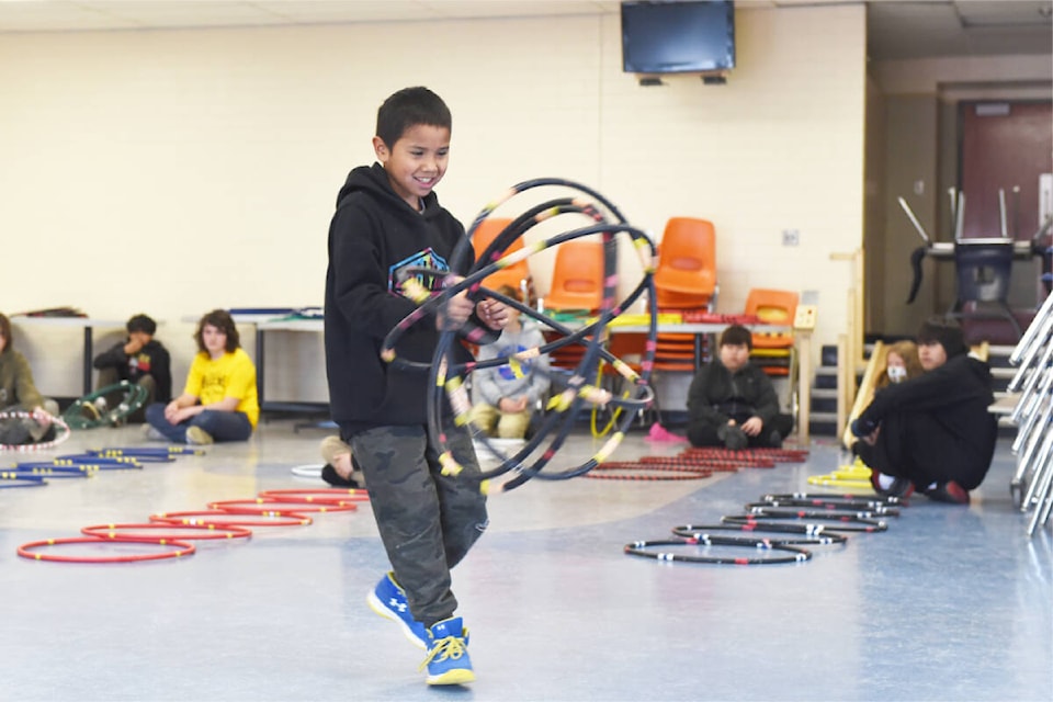 Kyrann Wycotte, in centre, a student from Marie Sharpe was helping demonstrate different hoop dance moves for a Grade 7 class at Lake City Secondary School - Columneetza campus. Francis Johnson was teaching the final in a series of three workshops for the group on May 27. (Ruth Lloyd photo - Efteen)
