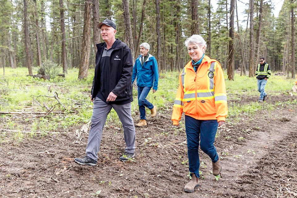 John Walker, stewardship forester for Williams Lake First Nation on left, tours Minister Katrine Conroy through an ecosystem restoration project in the Bond Lake Road area near Williams Lake. The project also helped reduce wildfire risk in the area. (Felipe Fittipaldi photo)