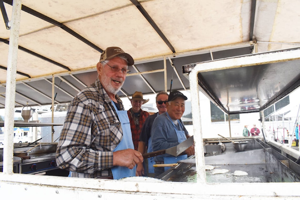 Don Lyons, left, Dick Kozuki, Ric Durfeld and Gene Sapp are busy cooking for the Knights of Columbus Stampede Breakfast underway at Save-on-Foods Thursday, June 30. (Monica Lamb-Yorski photo - Williams Lake Tribune)